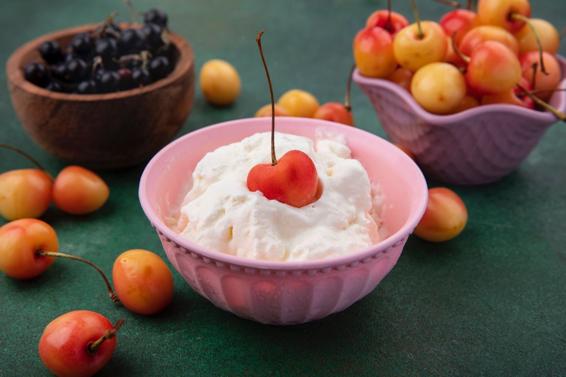 A bowl of fruit sitting on a table  Description automatically generated