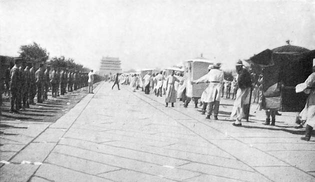 The Funeral of Yuan Shih-kai: The Procession passing down the great Palace Approach, with the famous Ch'ien Men (Gate) in the distance.