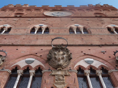 Palazzo Pubblico, with the arms of the Medici and the badge of San Bernardino.