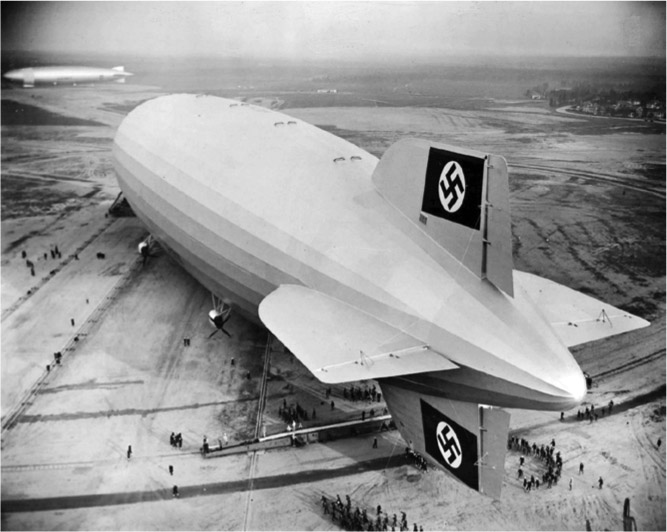  Men look like ants next to the massive Hindenburg at Lakehurst, New Jersey, in 1936. WIKIMEDIA COMMONS