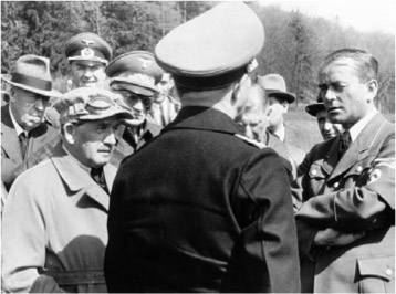  Hugo Eckener, far left, listens in as Hitler’s arms minister, Albert Speer, speaks to a German air force officer in August 1943. ULLSTEIN BILD/GETTY IMAGES