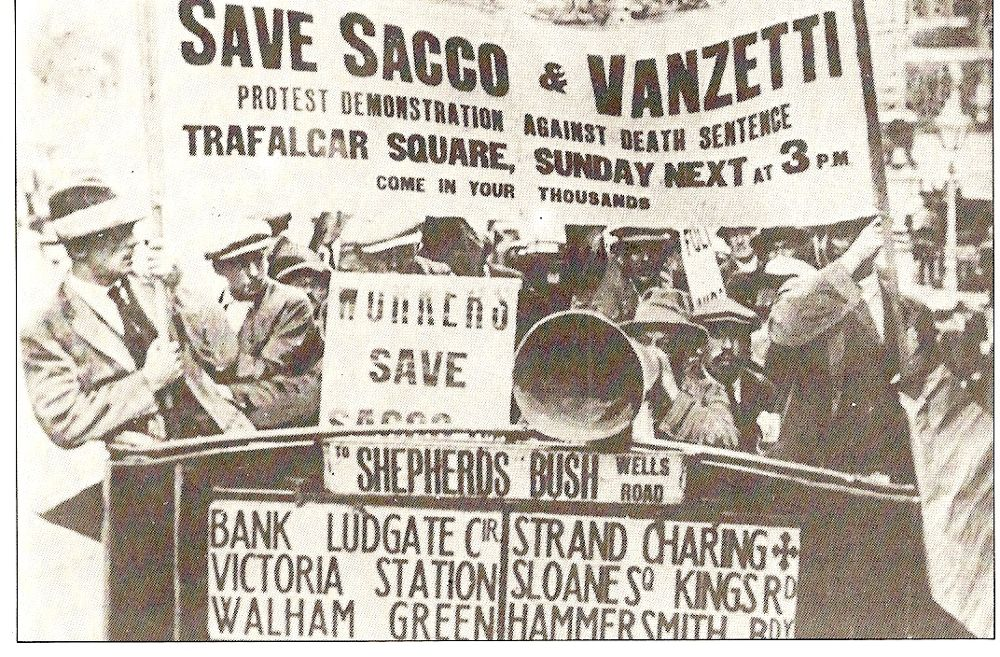 A group of protesters hold up signs to save Sacco and Vanzetti and against the death sentence.