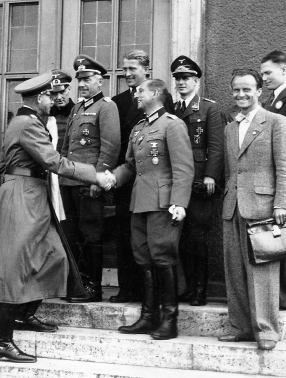 Gen. Erich Fellgiebel, head of the German army’s Information Services, congratulates members of the Peenemünde team for the first successful launch of an A-4 (V-2) rocket on October 3, 1942. Von Braun looks on from rear center. ...