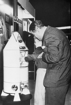 Von Braun helps a young boy get a good look at a space-theme exhibit in this undated file ...