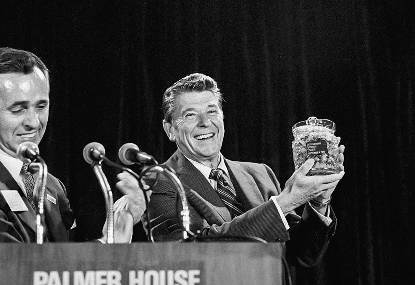 (Original Caption) 9/9/80-Chicago, Illinois: Republican presidential candidate Ronald Reagan holds a crystal jar of jellybeans presented to him 9/9 by Clyde Dicky, Jr., president of the International Business Council. In his address, Reagan offered a five-point program he promised would be instituted his first 90 days in office. Ph: Ron Edmonds