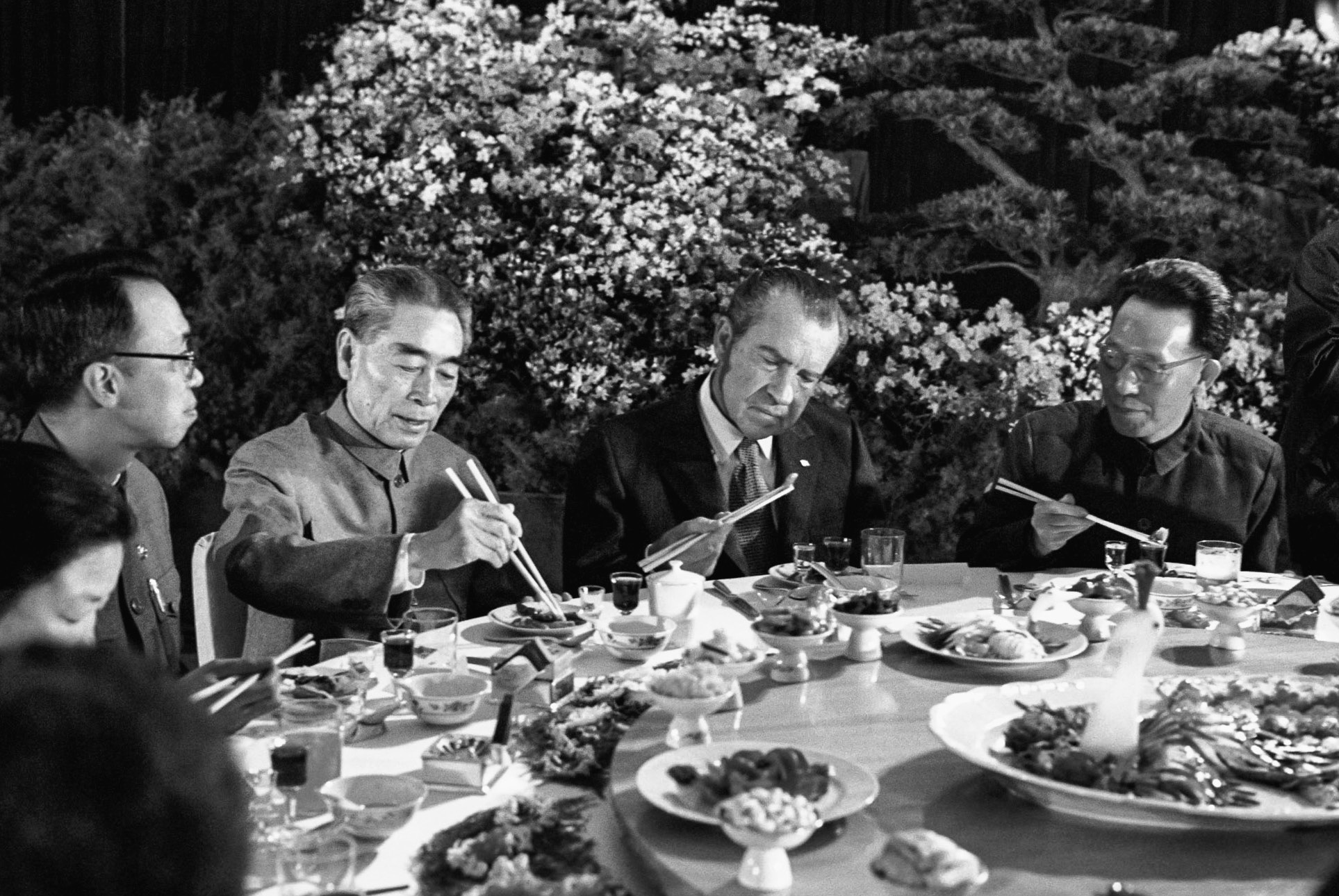 President Nixon gamely tries out his chopsticks at a banquet given in his honor