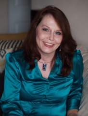 A person in a teal blouse

Description automatically generated