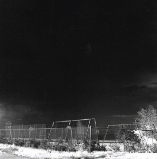 Carole Gallagher, Deserted Schoolyard in Amargosa Valley, 10 miles south of Nevada Test Site, 1988.