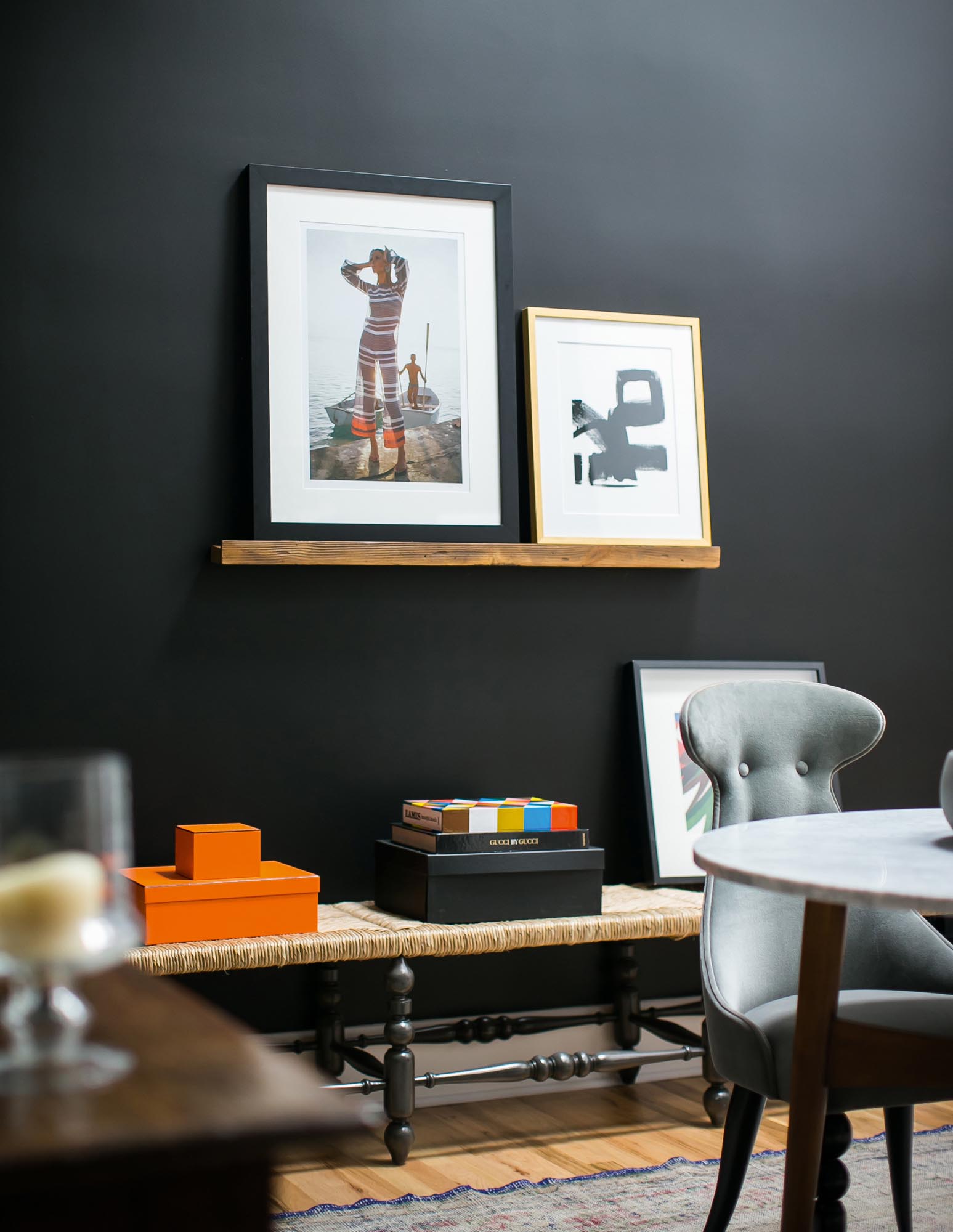 A black wall provides a dynamic gallerylike ambiance to the paintings and other art pieces in the client conference room.