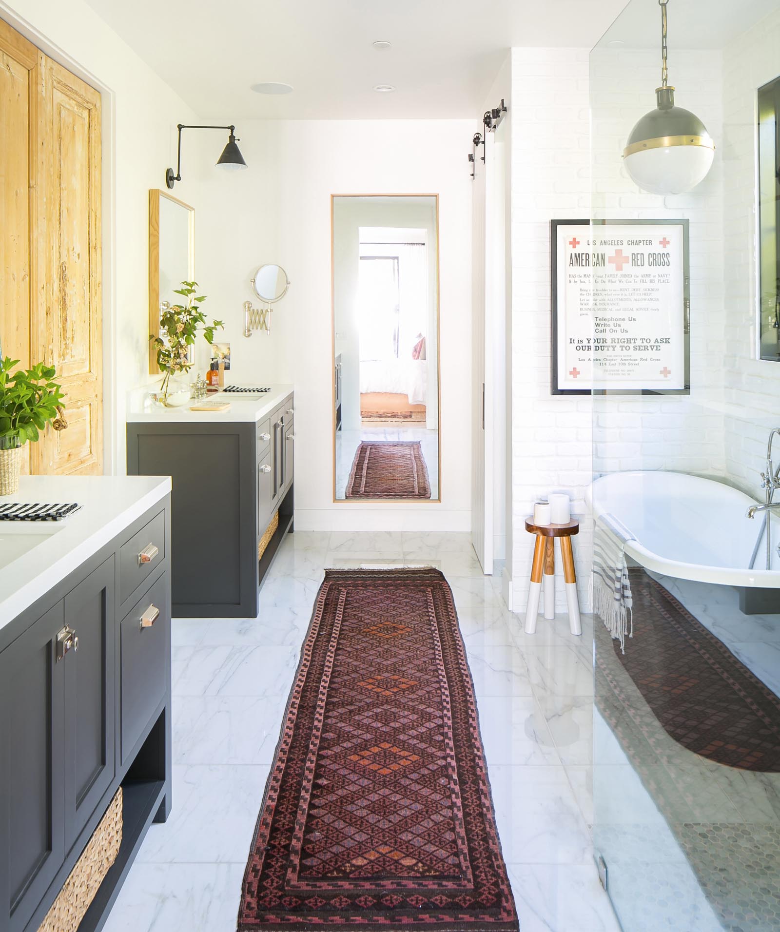 A Persian runner in the master bath with Jack-and-Jill vanities reflects Ashley’s love for the unexpected.