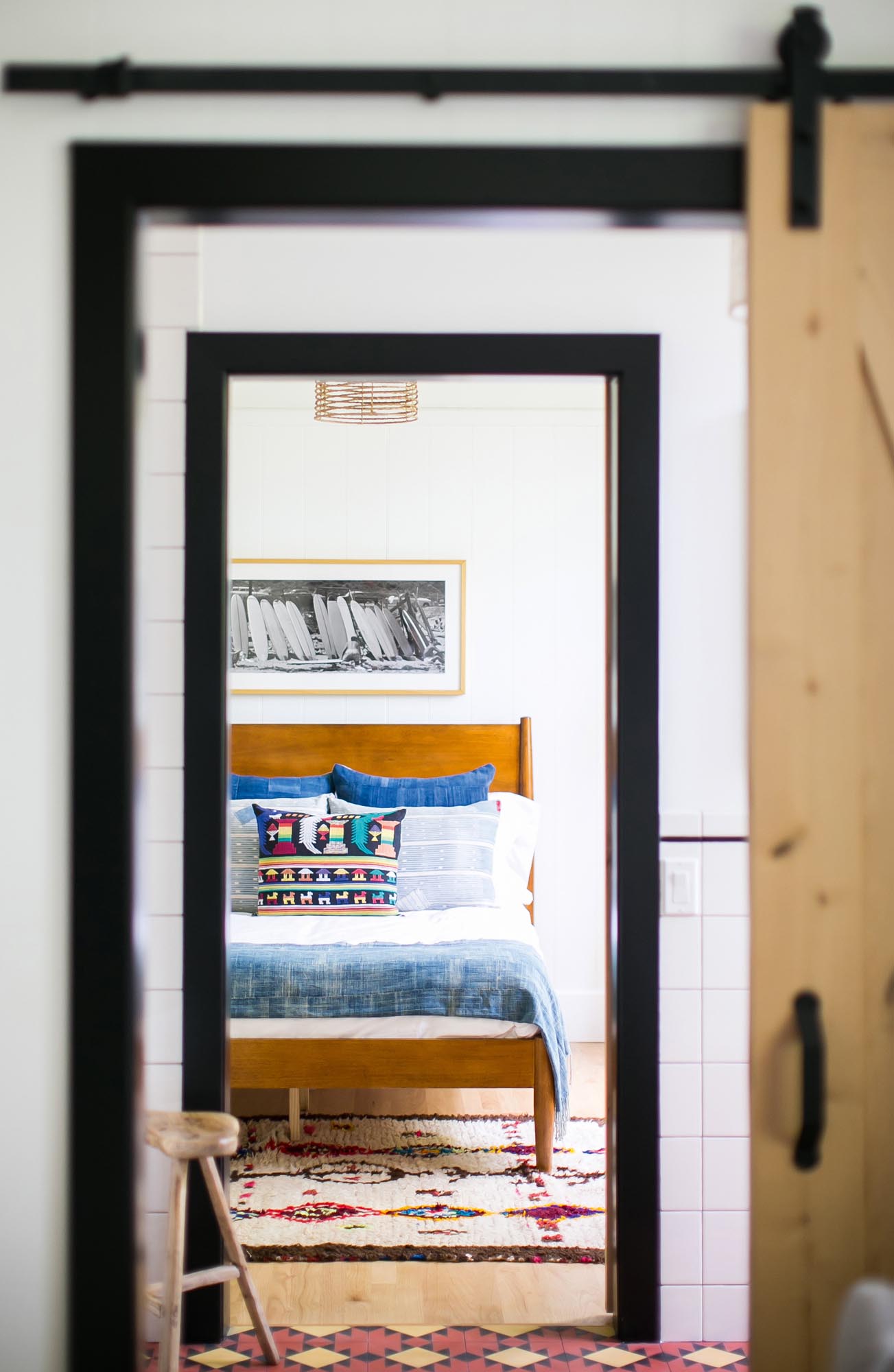 A free-flowing natural wood slider opens to a masculine bedroom.