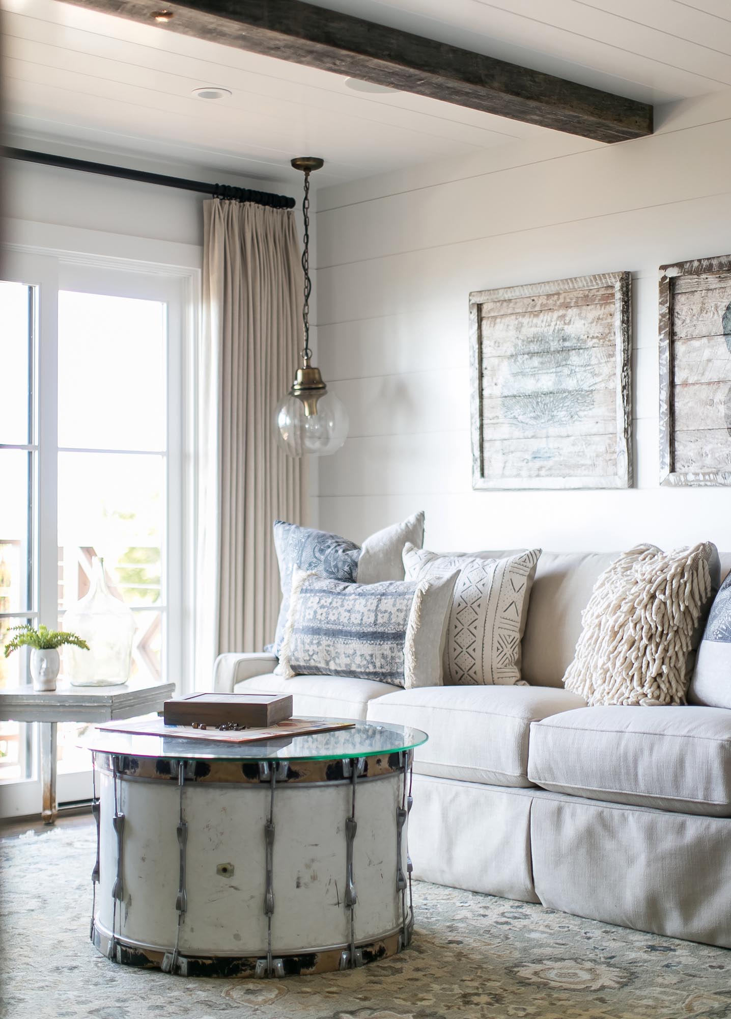 The repurposed bass drum from a ’60s rock band makes the perfect table for this room.