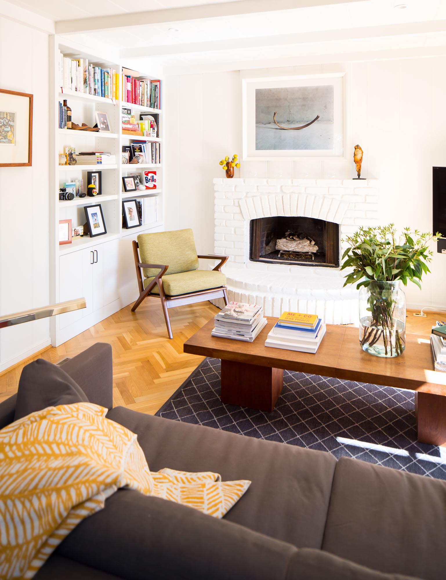 The family enjoys this comfortable family room with woodburning fireplace.