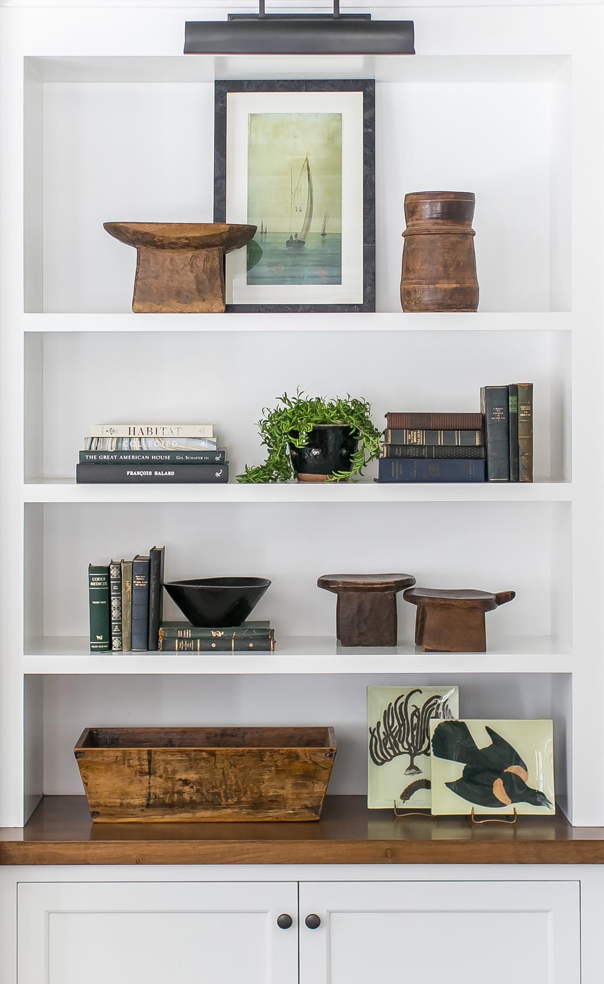 With new architectural changes to the cottage came an abundance of shelving upon which to feature collected pieces and family heirlooms.