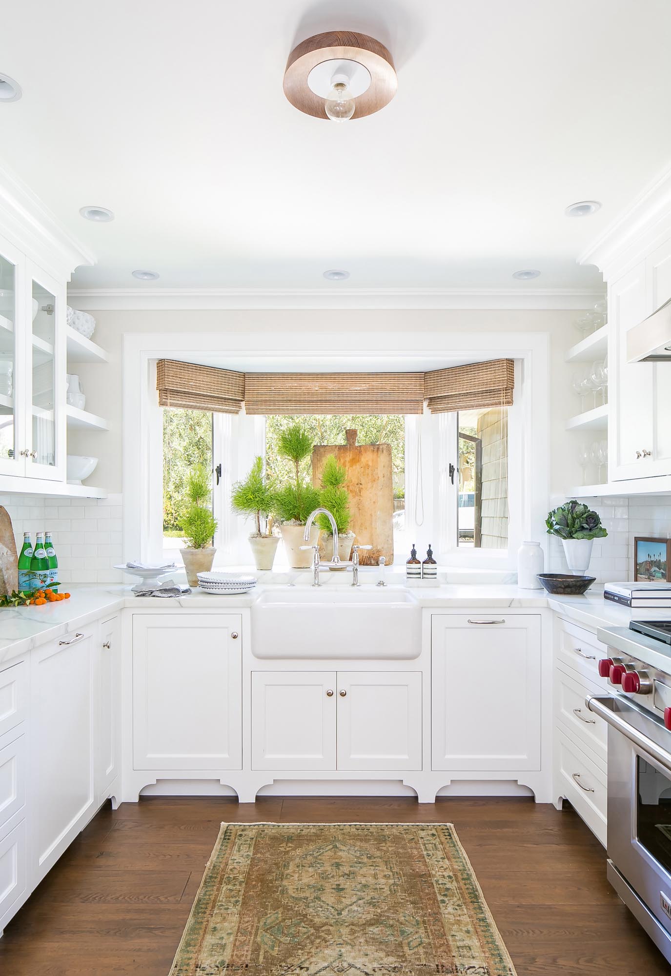 The French oak hardwood floors extend into the kitchen and provide a vintage contrast to the contemporary kitchen cabinetry.