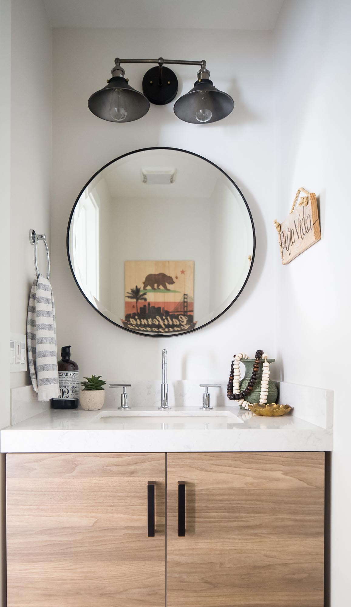 Black, white and custom wood cabinetry lends perfect pitch to the bathroom.