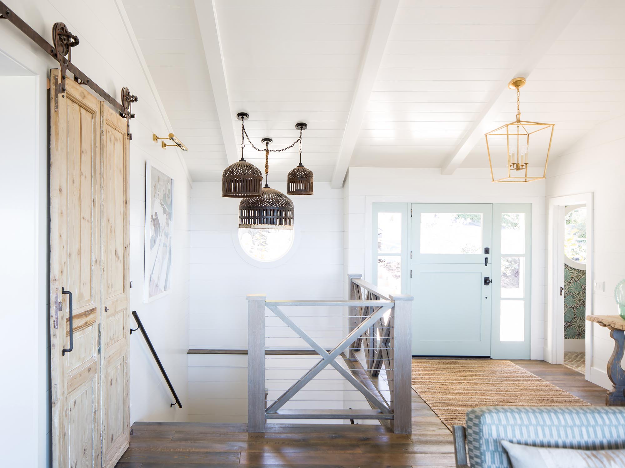 Laurie commissioned original lighting for several areas of the home, including this trio of hanging shades made from vintage bird cages.