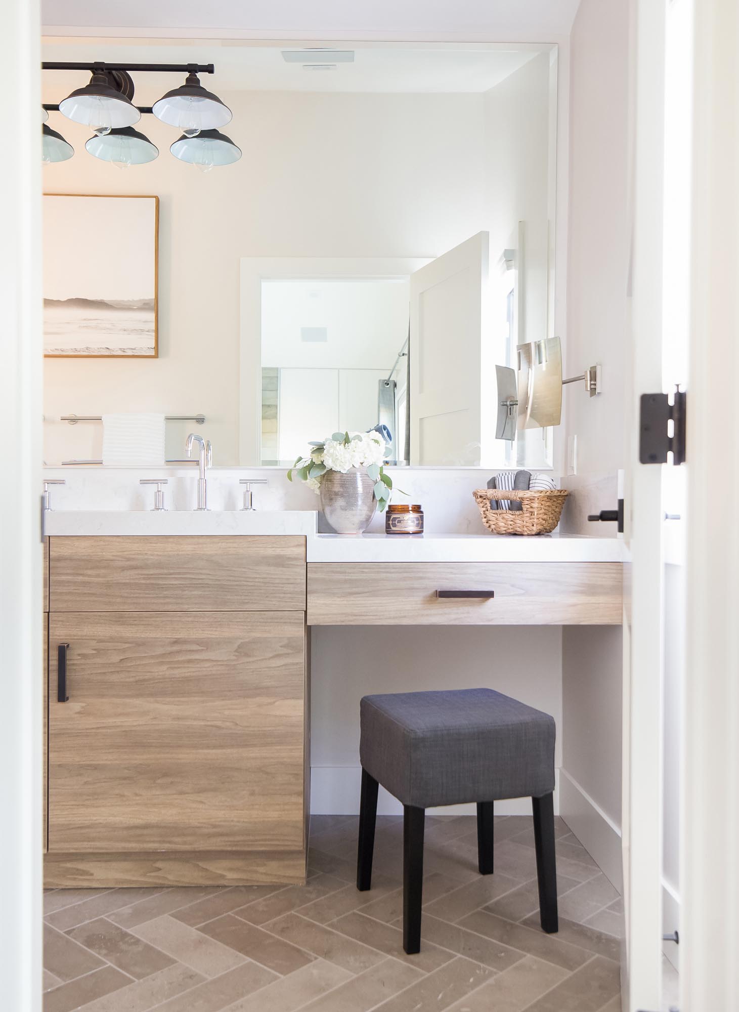 Custom wood cabinetry complements the chevron-patterned bathroom floor.