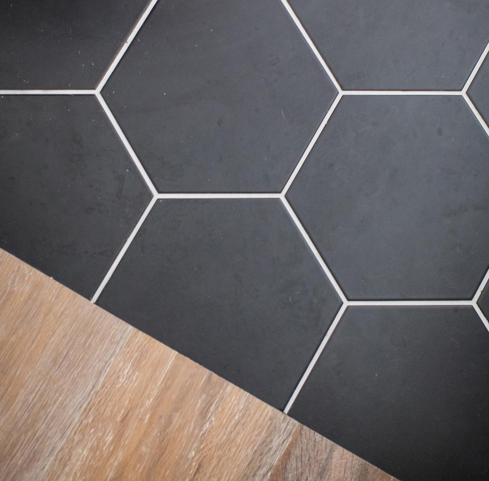 The polygon black tile completes the black and white bathroom.