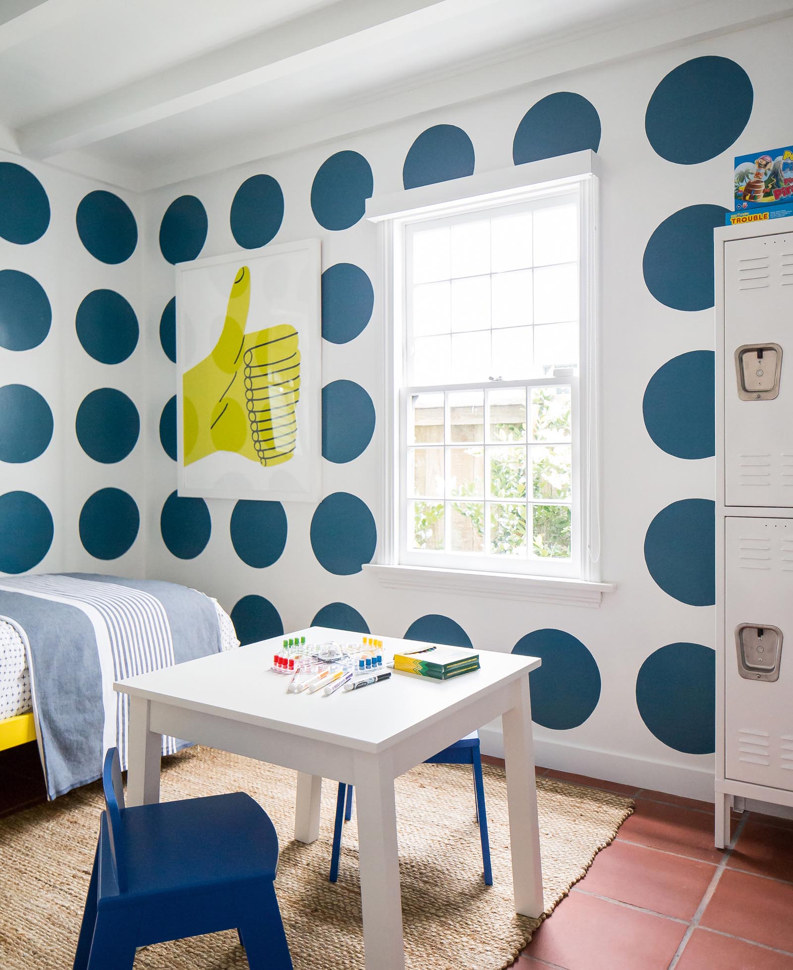 The grandchildren’s rooms are alive with colors. In one bedroom, large blue polka dots fill two walls—totally unexpected yet complementary to the clean lines throughout the rest of the cottage.