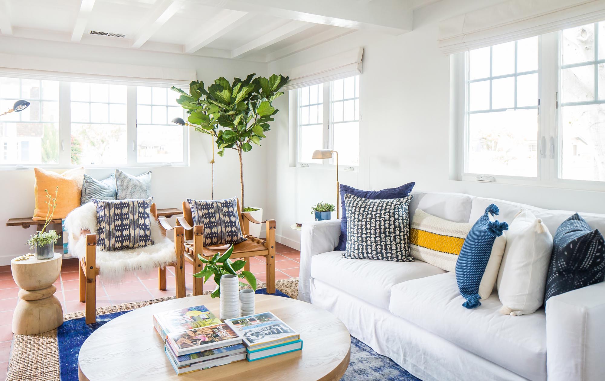 Photo of living space with white walls and blue pillows.