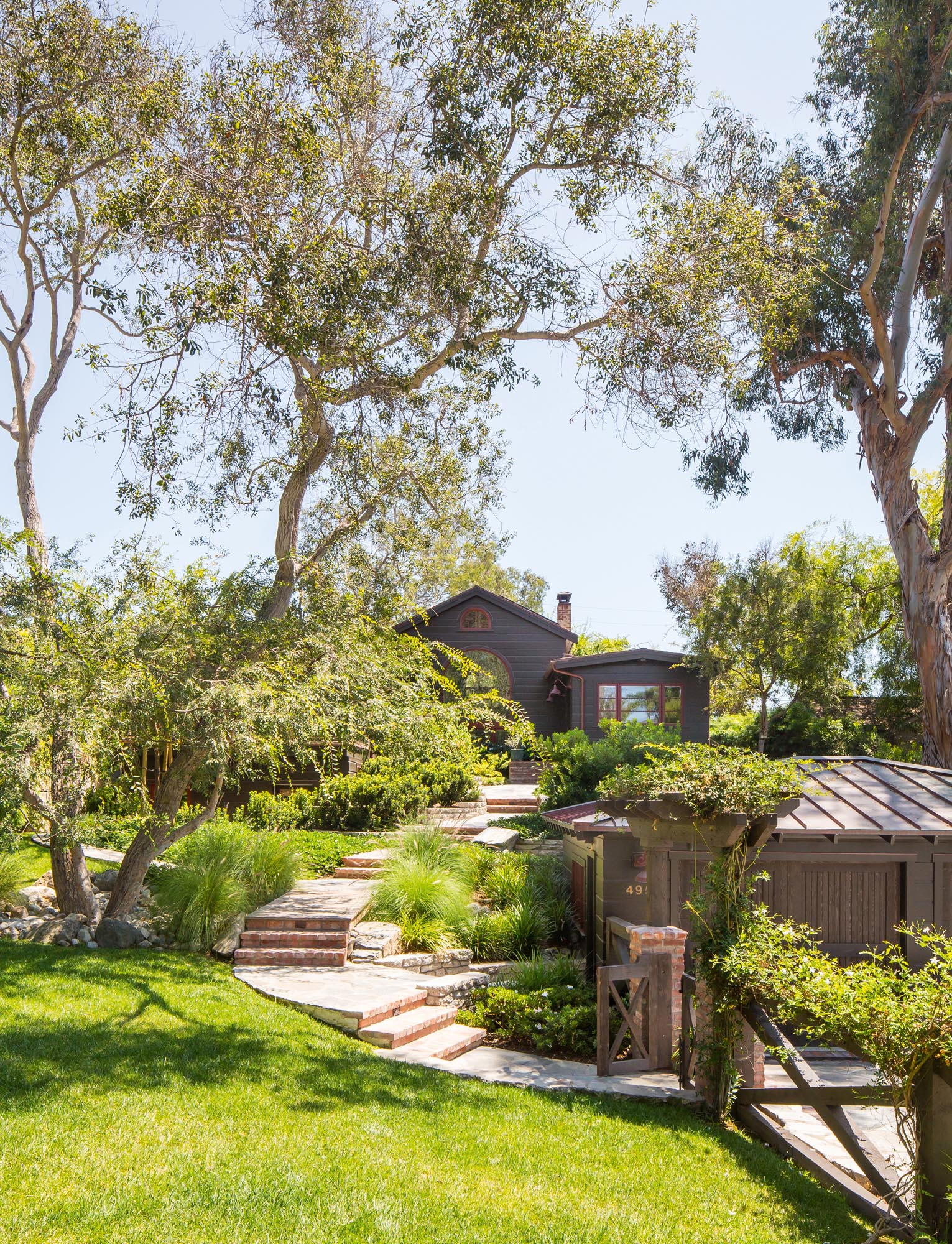 Photo of long brick path from garage to the cottage.