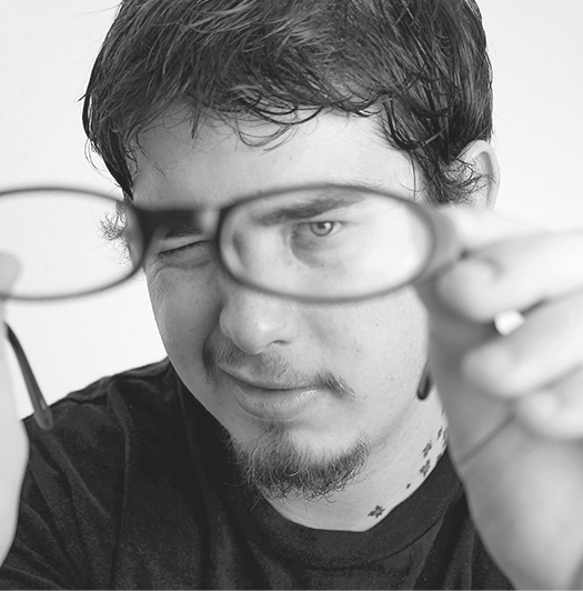 G2FJ8C Young Adult Man Looking Through Eyeglasses