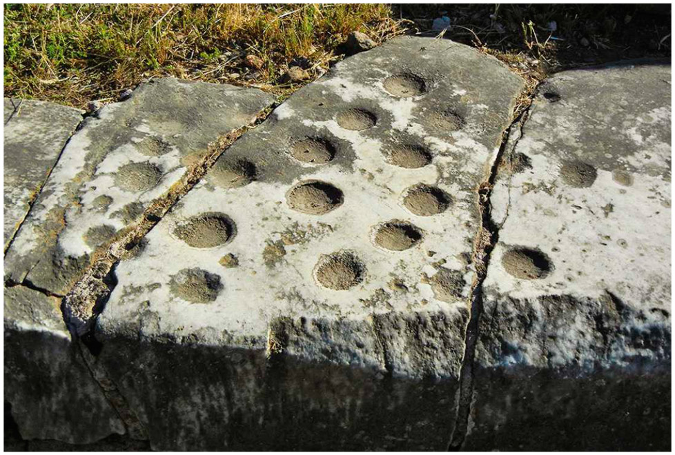 Figure 1.5. Game board carved into the marble steps of the Basilica Julia courthouse. The rules of the game are unknown, but it may have been something like mancala.