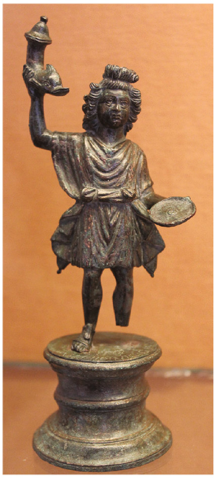 Figure 2.5. Another example of the lares (singular lar), or household idols. Note the plate in the deity’s left hand, which could have been used for the placement of a small offering of food as part of a mealtime ritual. (National Archaeological Museum, Naples)