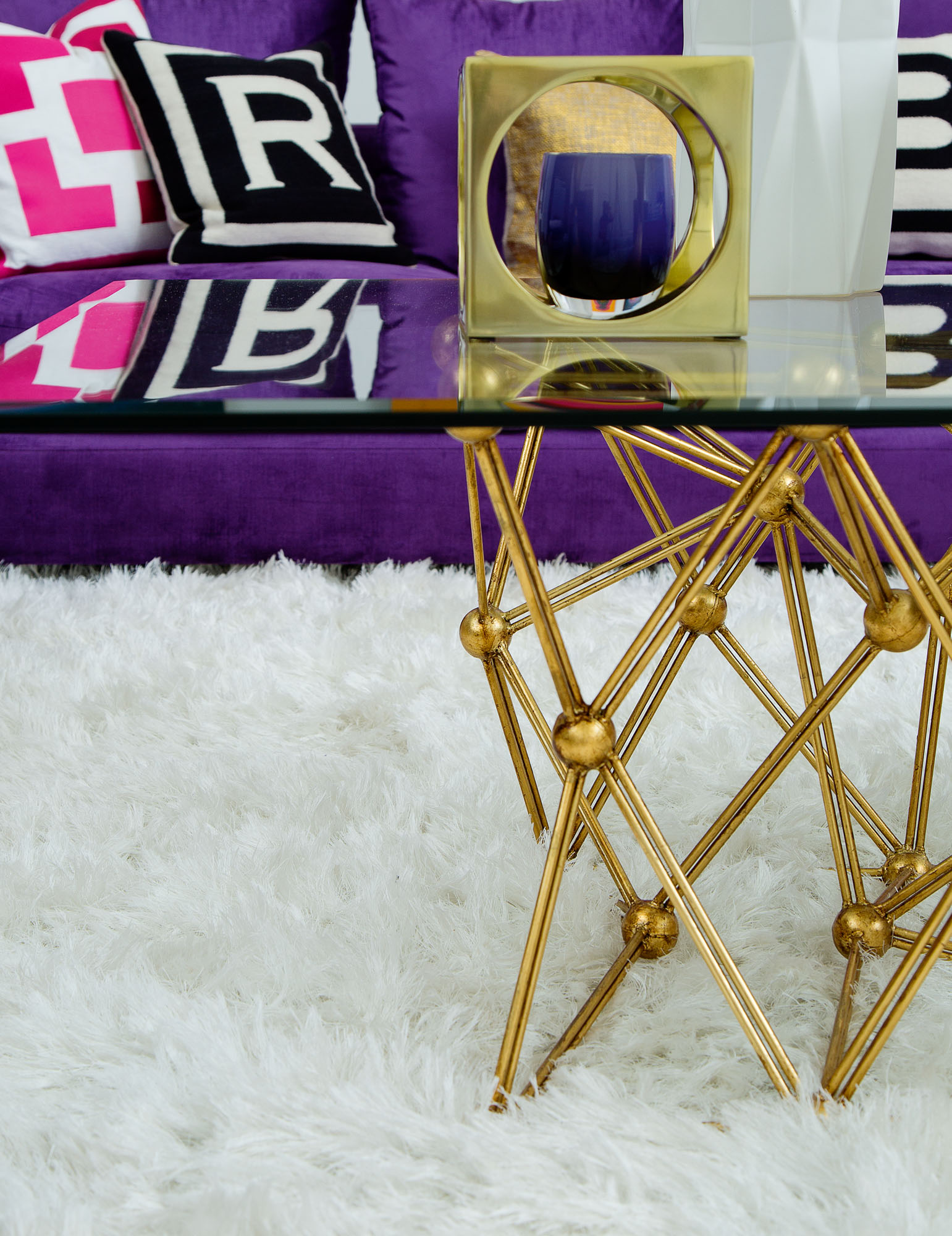 Photo of glass and brass table.