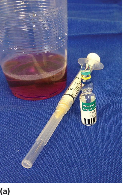 Photo displaying juice in a disposable cup, a syringe, and an ampul of midazolan.