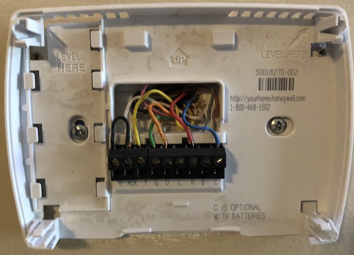 Figure 50: For my HVAC system, the C-wire is the blue one. Note how the thermostat mount says “C is optional with batteries”—most thermostats that use batteries don’t need the additional power the C-wire provides.