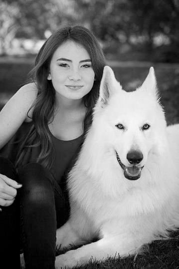 Chloe and Aslan seated outside on a lawn