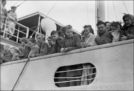 Survivors line the rail of the Knute Nelson