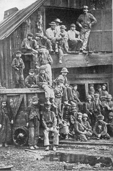 YOUNG BOYS FROM THE PIT. A group of workers in a coal mine during dinner-time. Many even younger work on the night shift. (Courtesy of the Ridgway co.)