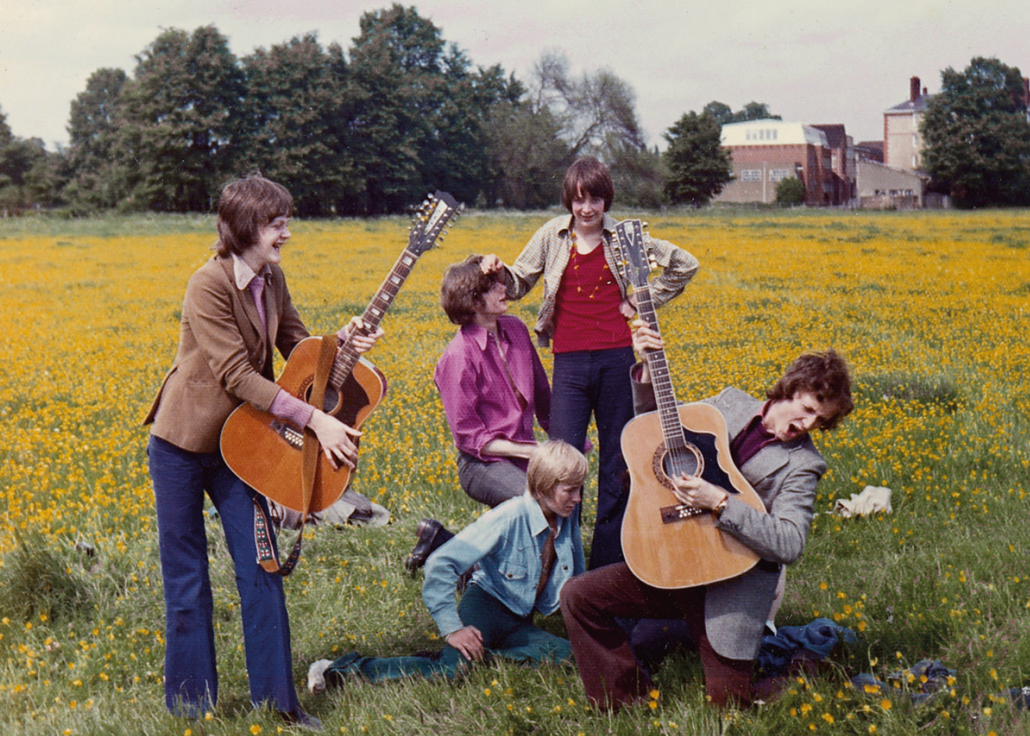 Jamming on South Meadow, Eton, circa 1973. Craig Brown on the left in bellbottoms, David Shaughnessy on the right. James Baring, centre, with red T-shirt and necklace.