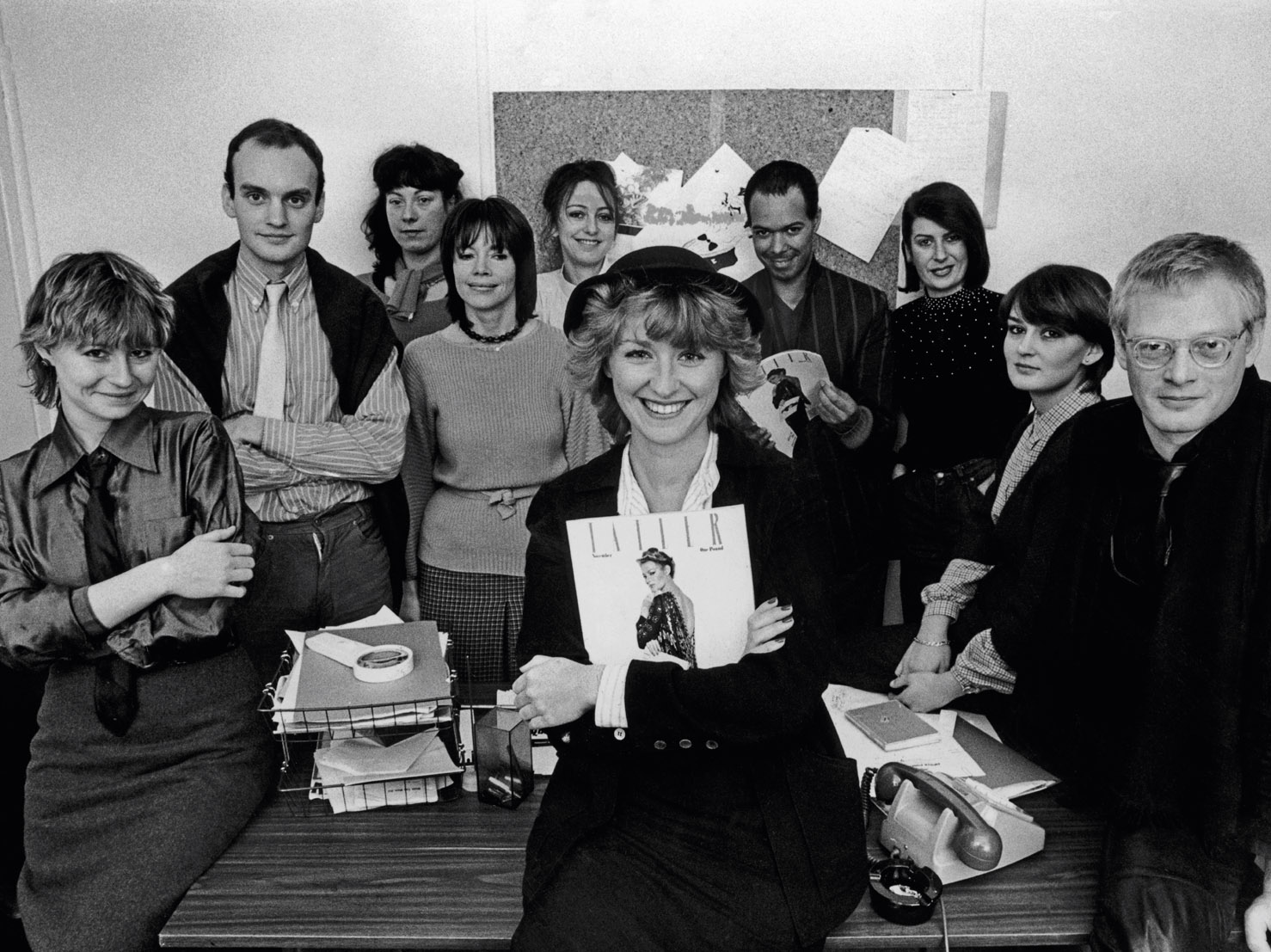 The editorial team at Tatler, October 1979, photographed in the offices at 15 Berkeley Street. Tina Brown, front centre, clutching her first issue. NC in the back row with Georgina Howell and Michael Roberts.