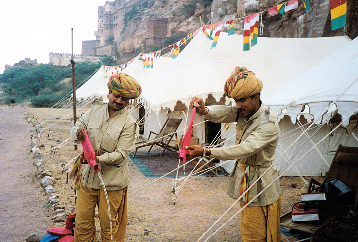 The hot-water bottle men on a Rajasthan trip; the filling and emptying of hot water bottles was their only job, expertly done. The tents are pitched below Mehrangarh Fort, Jodhpur.