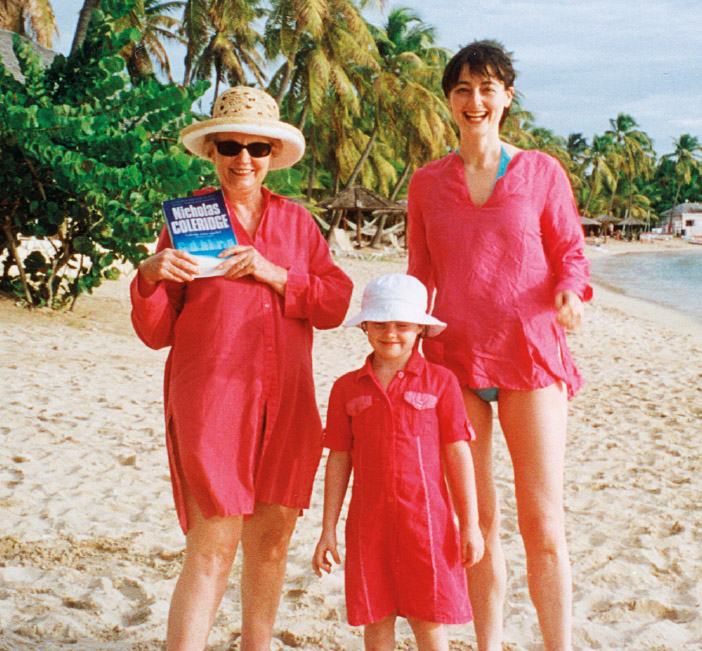 Susan, Sophie and Georgia Coleridge loyally displaying a copy of Godchildren on a beach in Antigua.