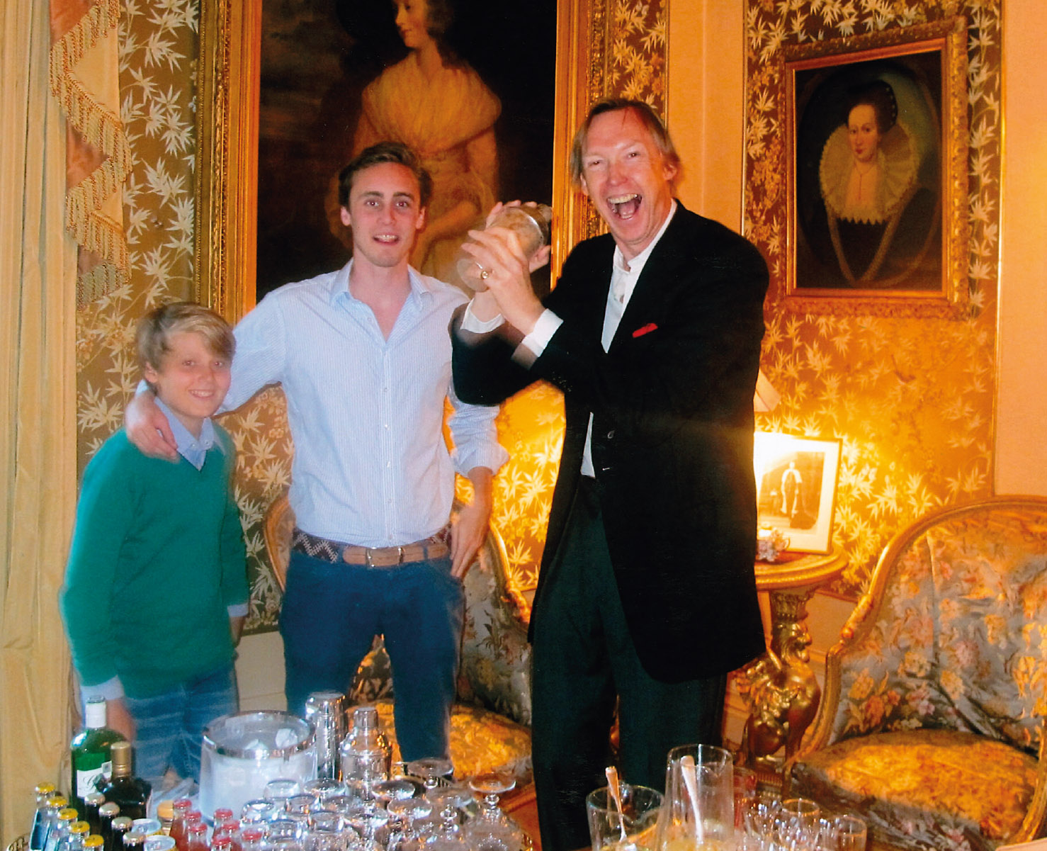 Sotheby’s Chairman James Stourton shakes the cocktails while Tommy and Alexander Coleridge look on. Photographed in the gold drawing room, Marcus, By Forfar, Angus, scene of much fun.