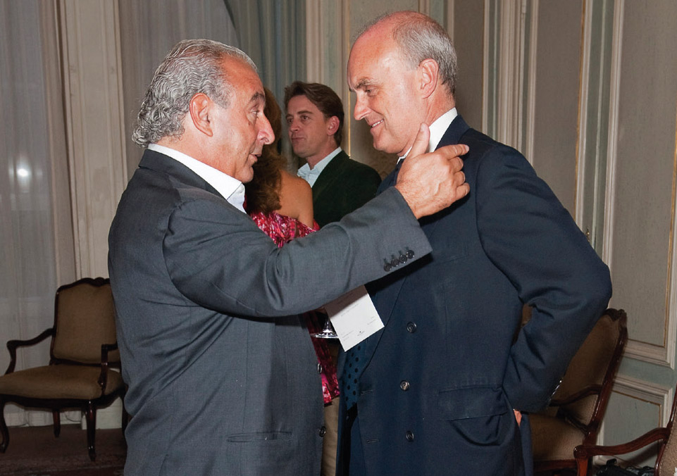 Sir Philip Green, billionaire retailer and philanthropist, imparts management wisdom to NC at a Vogue party, Claridge’s, 2010. Photograph by Nicholas Harvey.