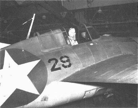 On 10 Aug. 1942 Rad. Elec. Thomas Rhodes of VF-6 sits in F-29 in the Enterprise’s hangar deck.
