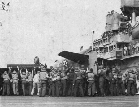 Wasp flight deck crews lift Lt. (jg) Fred Hamilton’s F-23 (BuNo. 5103), wrecked in a landing accident on 7 Aug. 1942. (NA 80-G-12623)