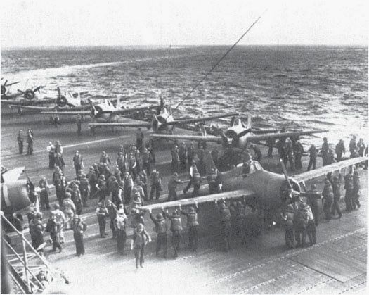 Wasp plane handlers park VF-71 F4Fs on deck, 9 Aug. 1942. In the foreground is F-2 (BuNo. 5031), wrecked in an accident in mid-August. (NA 80-G-14027)