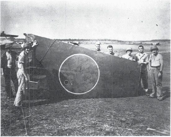 One wing from Spec. Duty Ens. Takamatsu Naoichi’s Kisarazu Type 1 land attack plane, destroyed on 12 Sept. 1942 by the 3rd Defense Battalion. In the left rear is a PBY-5A Catalina amphibian. (NA 80-G-16328)