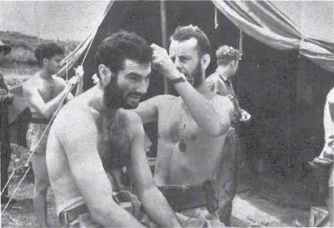 George Morgan cuts Weasel Wesolowski’s hair in front of the VF-5 ready tent; Crud Blair is behind to the left.