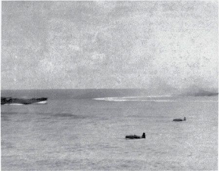 Two Zuikaku Type 97 carrier attack planes from the 42nd Shōtai head toward the South Dakota after firing torpedoes at the Enterprise.