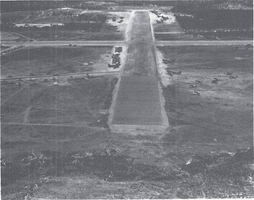 Tontouta airfield, 10 Nov. 1942. VF-10 F4Fs take off past VT-10 TBFs and R4D and C-47 transports. P-39s are parked to the right. (NA 80-G-29319)