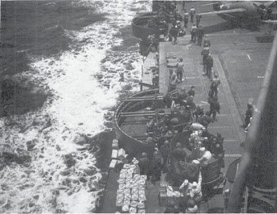 A pair of deadly 40-mm quadruple mounts on the Enterprise, 13 Nov. 1942. In the upper right corner is F-38, a repainted VF-72 Wildcat assigned to VF-10. (NA 80-G-30536)