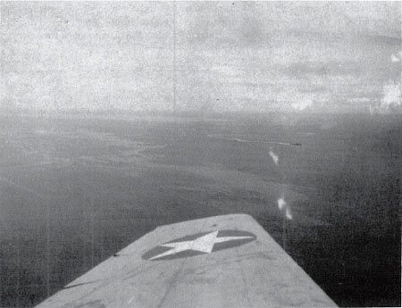 VT-10 TBF passes the heavy cruiser Suzuya on the morning of 14 Nov. 1942. (NA 80-G-30516)